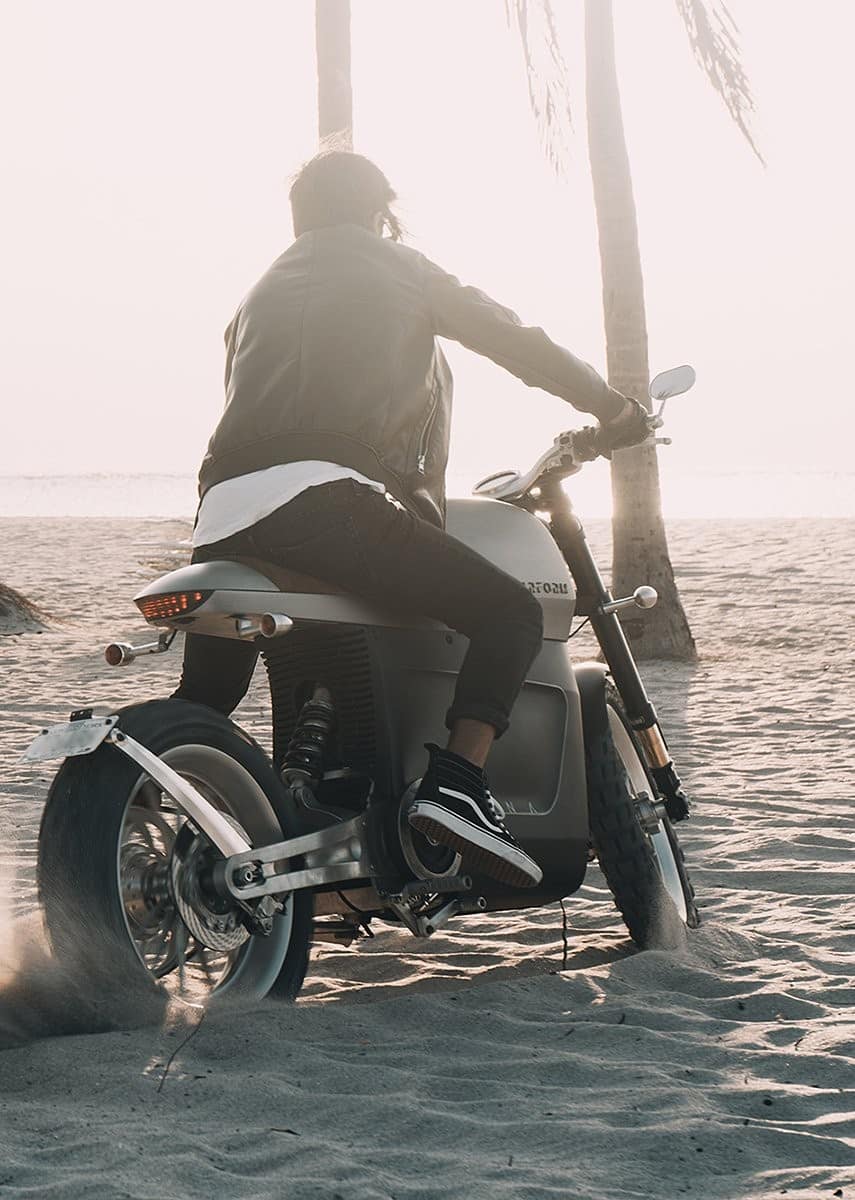 tarform scrambler electric motorcycle on beach.