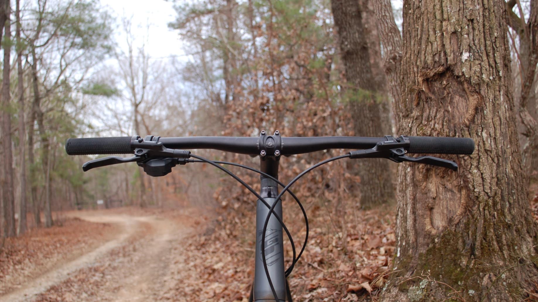 Electric gravel bike with a flat handlebar.