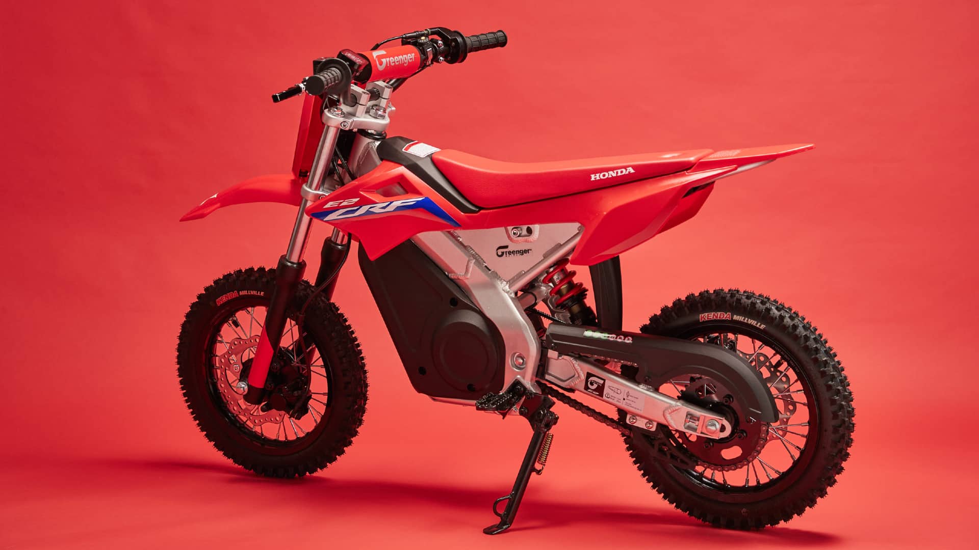 Electric Honda CRF-E2 dirt bike sitting in a studio.