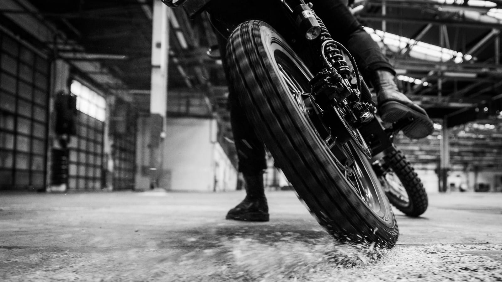 Black Tea Bonfire electric motorcycle action shot in black and white.