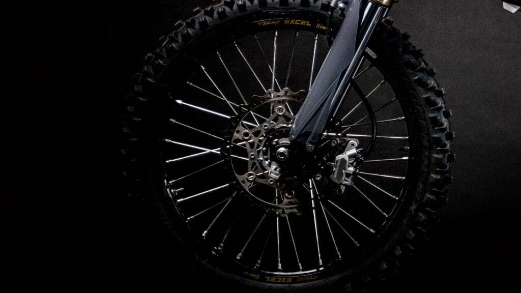 Close up of front wheel and tire combo for EMX electric dirtbike. 