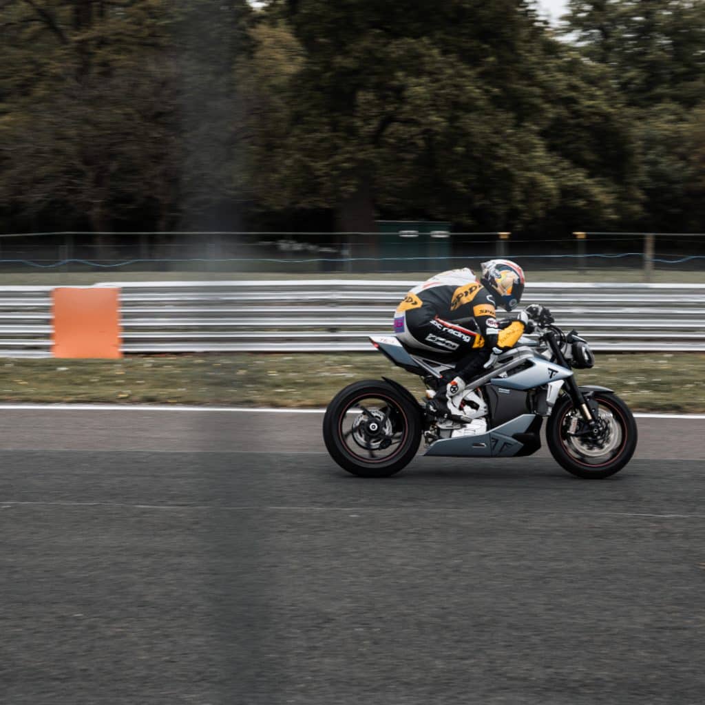 Triumph TE1 side view while riding on a racetrack. 