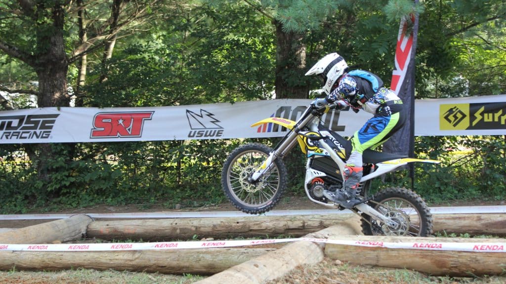 Sur Ron Storm Bee riding through hard enduro race course.