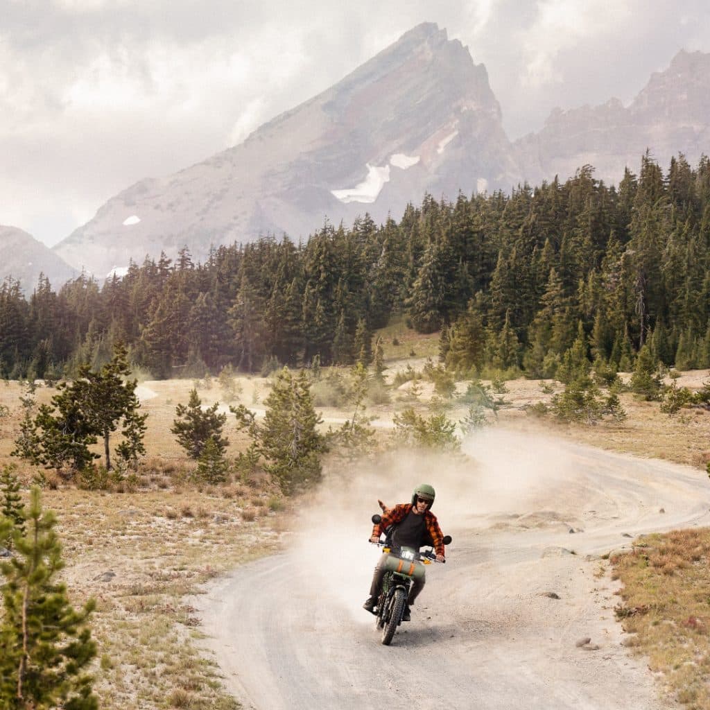 Riding the UBCO Special edition down a dirt road. 