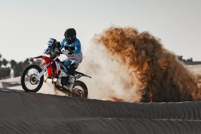 Action shot of an Arctic Leopard rally motorcycle at the 2026 Dakar Mission 1000.