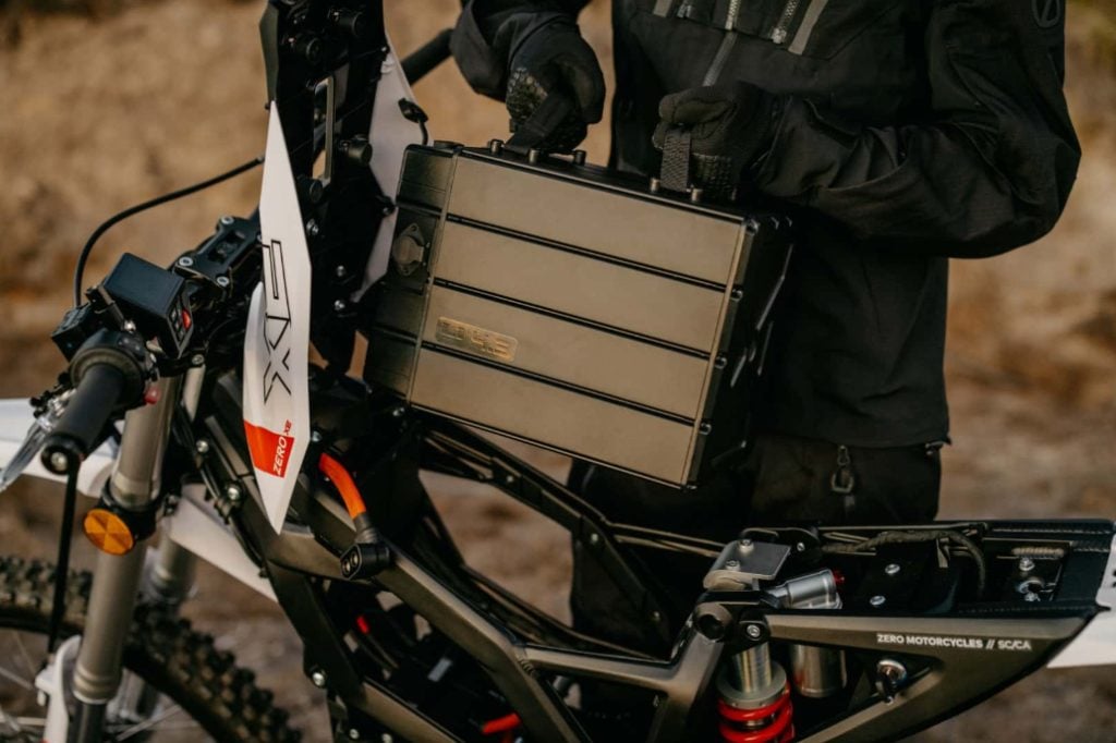 Man does electric battery care on a Zero XE electric dirtbike.