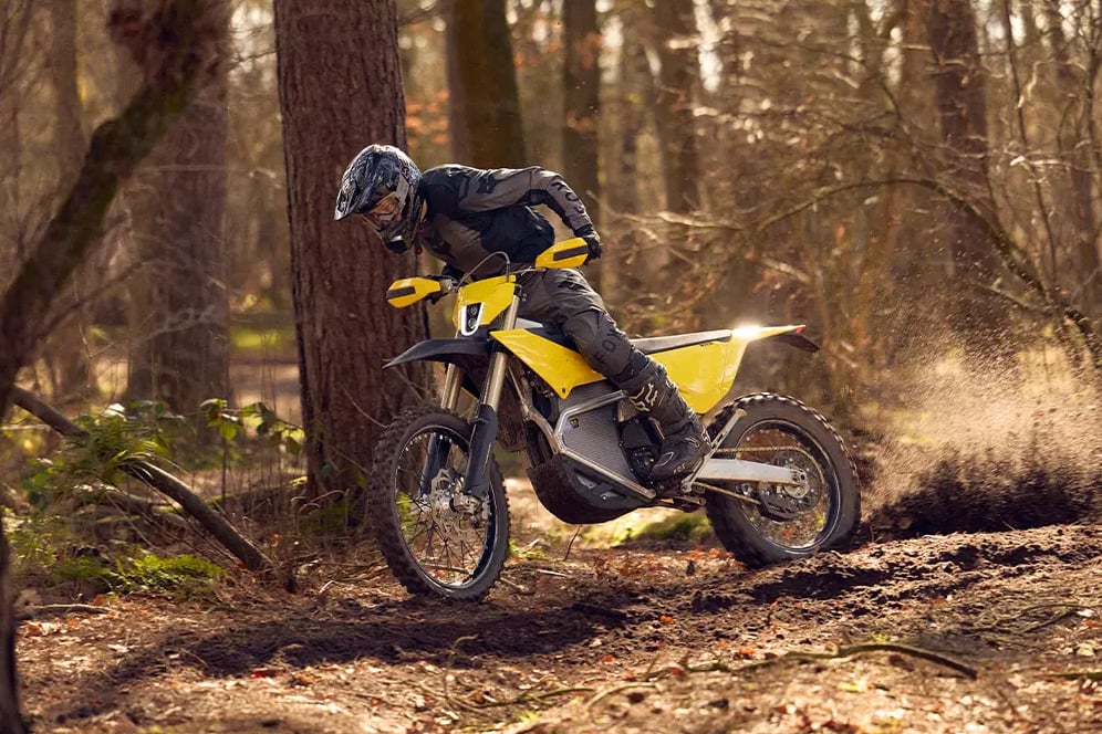 Radian EXR electric dirt bike going full gas on a trail. 