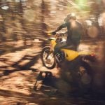 radian exr electric dirt bike throwing roost in the woods.