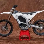 Rerode RX electric dirtbike parked in the middle of a motocross track.