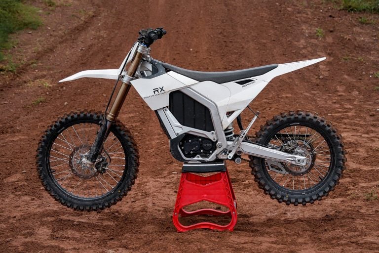 Rerode RX electric dirtbike parked in the middle of a motocross track.