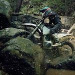 Bonnell 805 RX riding over a muddy creek bed.