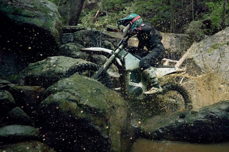 Bonnell 805 RX riding over a muddy creek bed.